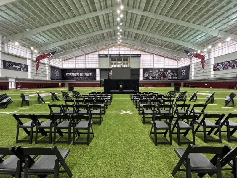 Chairs set up for presentation on Gamecocks field