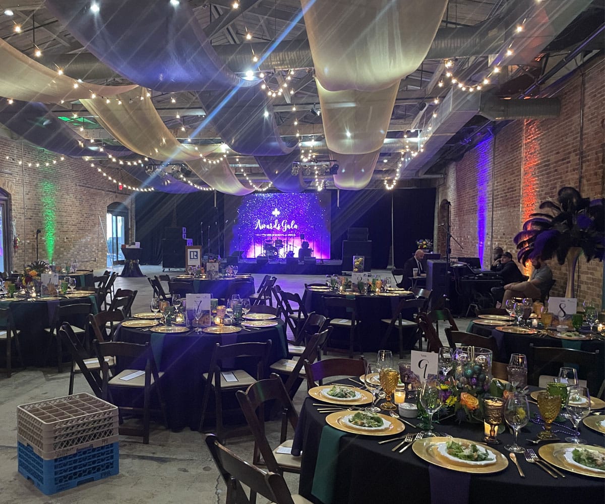 A Gala set up with tables and a stage.